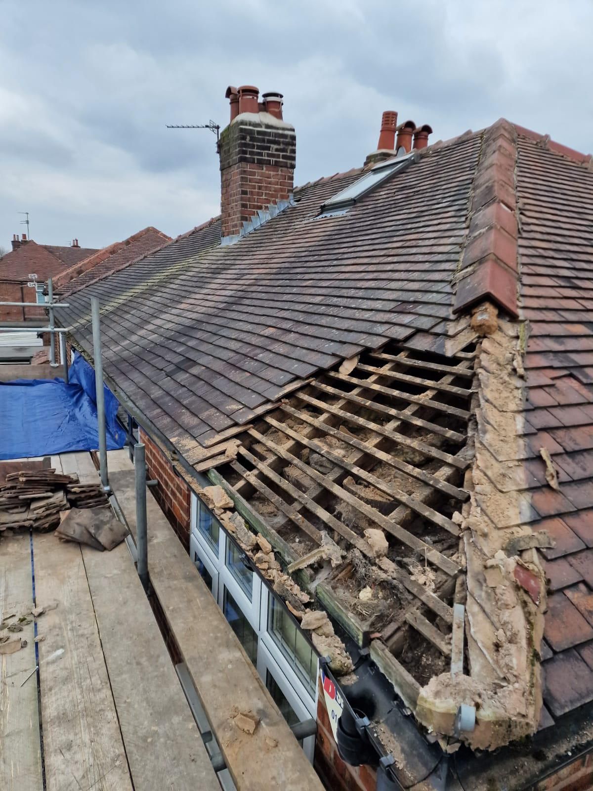 Rotten timbers and chimney exposed during a strip