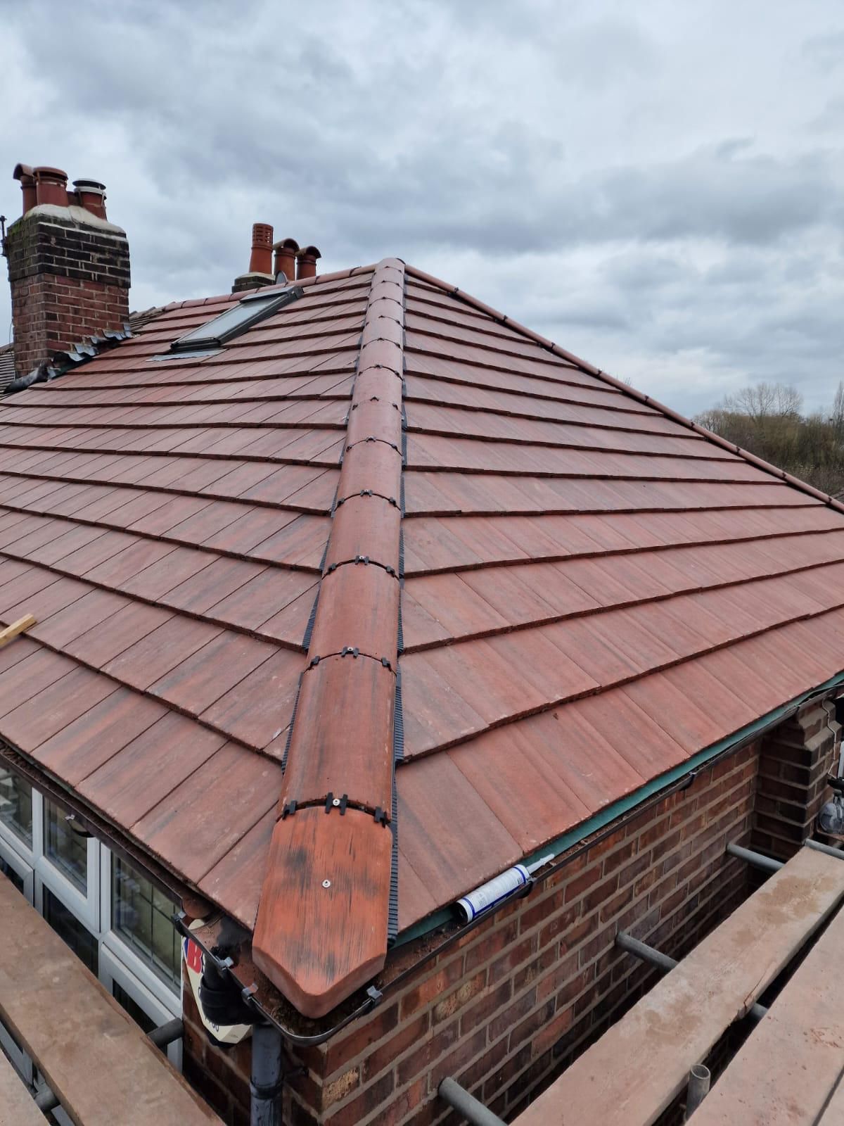 Completed tiled hip roof with re-pointed chimneys, Wrexham
