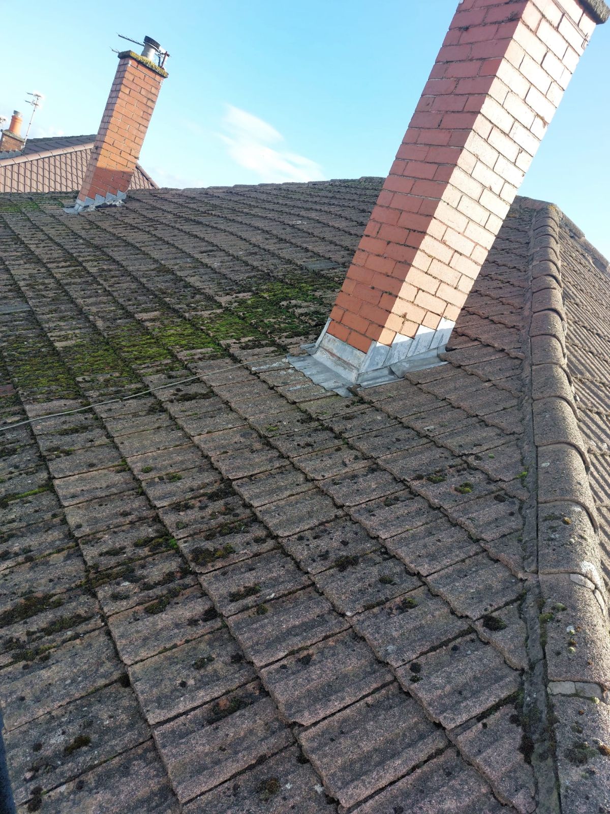 Ridge and chimney detail on a tiled roof